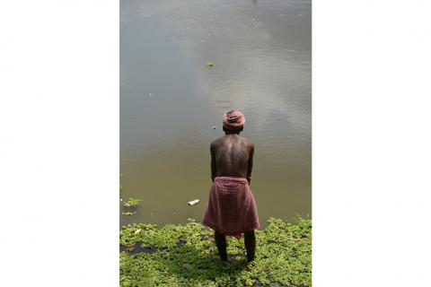 Village elder engaged in fishing in the pond