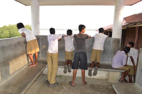 School children in Gosaba waiting for a boat to arrive 